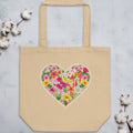 Beige tote bag with a floral heart design on a light gray background