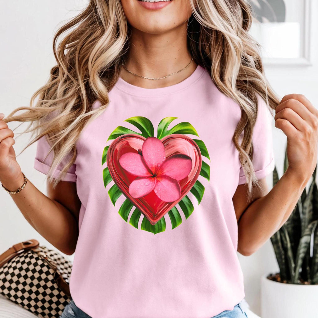 Woman wearing a pink t-shirt with a heart-shaped floral design.