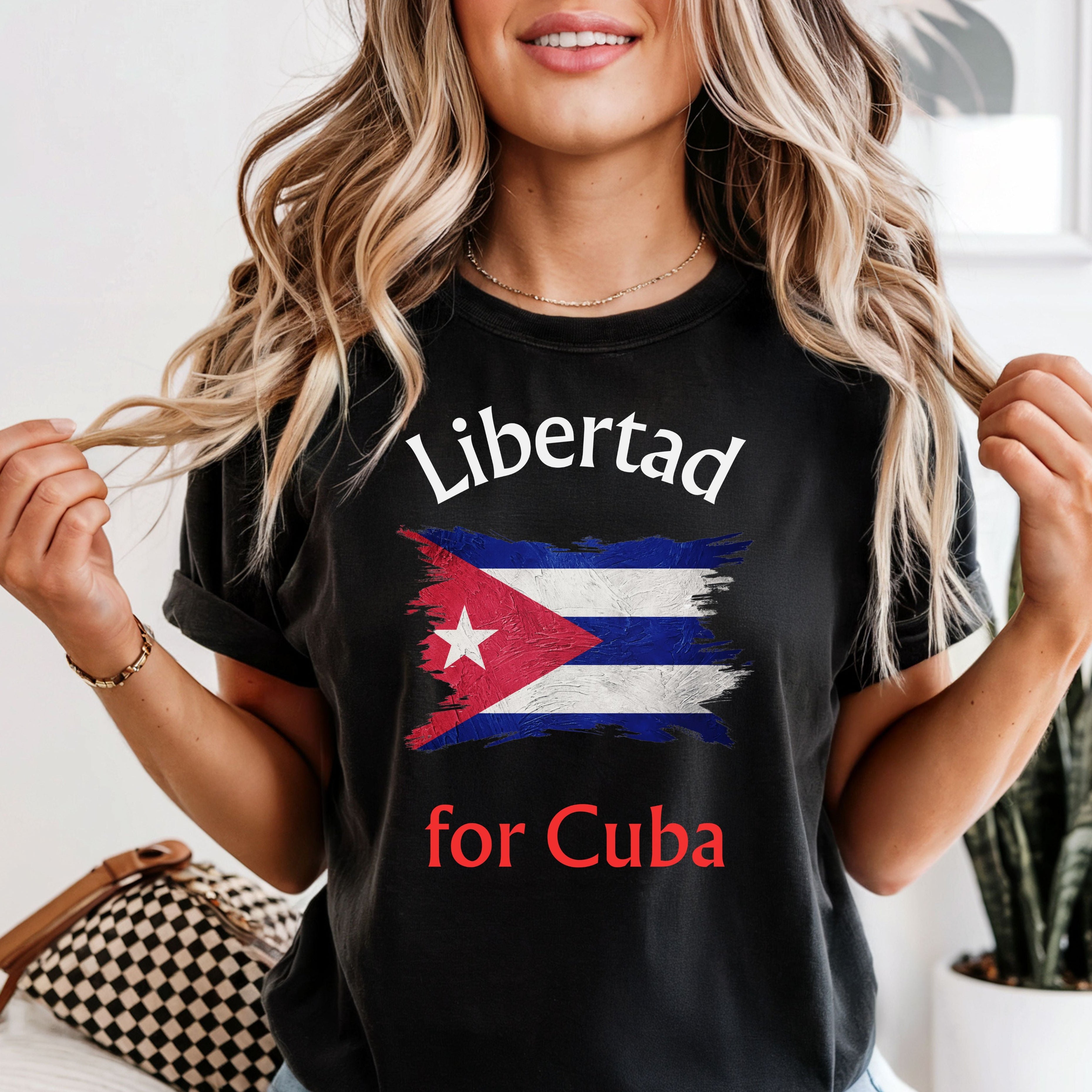 Person wearing a black t-shirt with 'Libertad for Cuba' text and flag design.