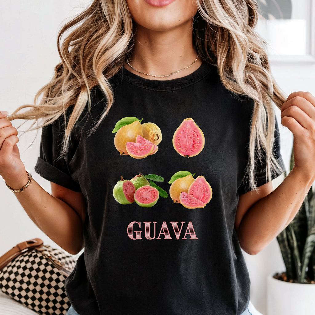 Woman wearing a black t-shirt with guava graphics and text.
